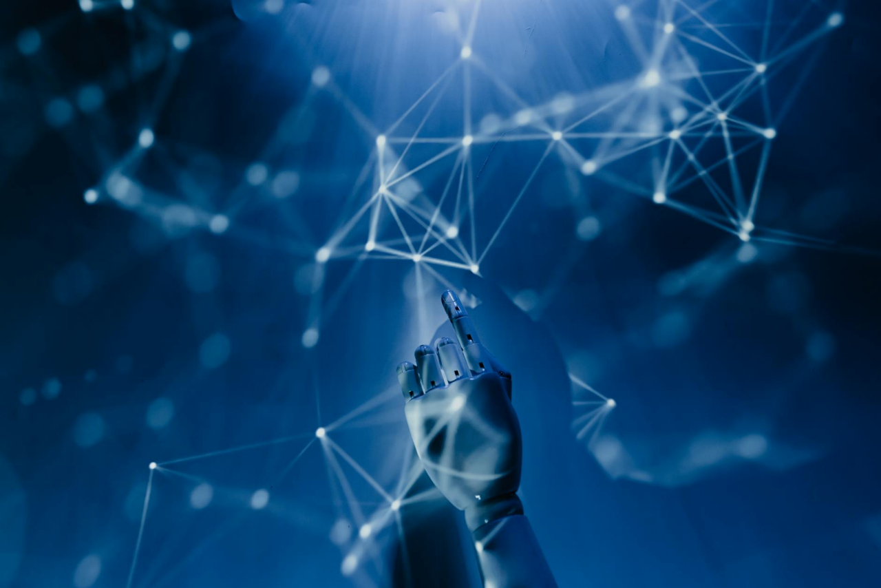 A robotic hand pointing up with a blue and white network web in the background