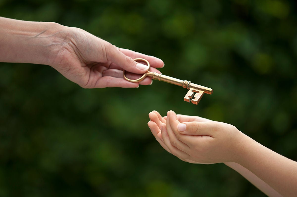 mother handing key to daughter