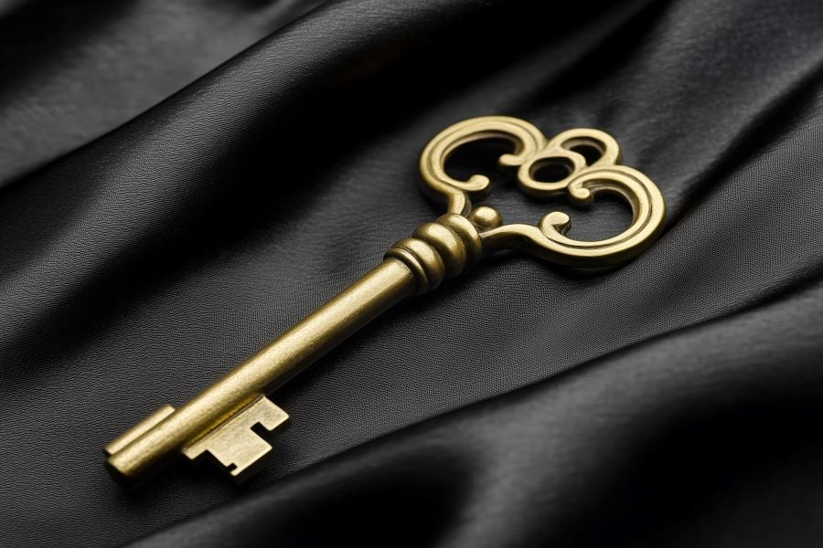 Gold key on black satin