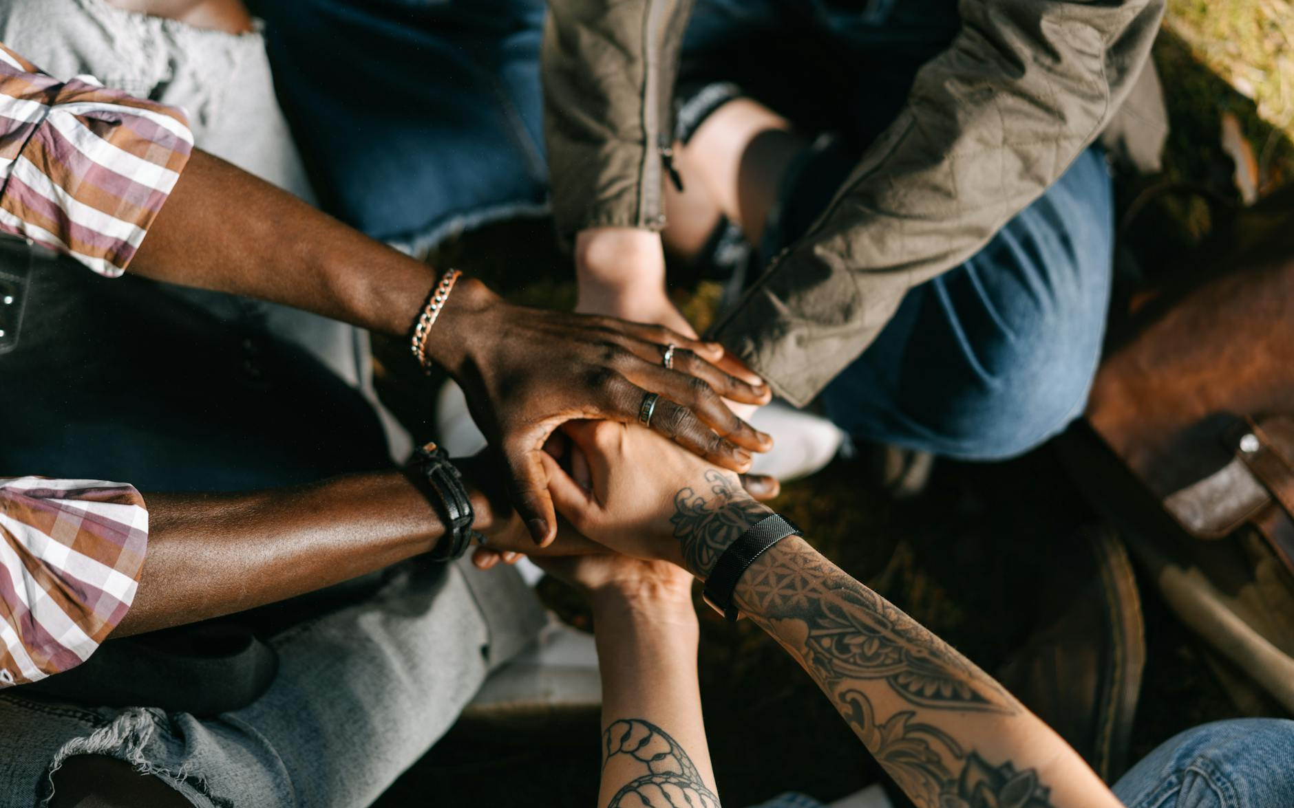 Diverse group of hands all coming together