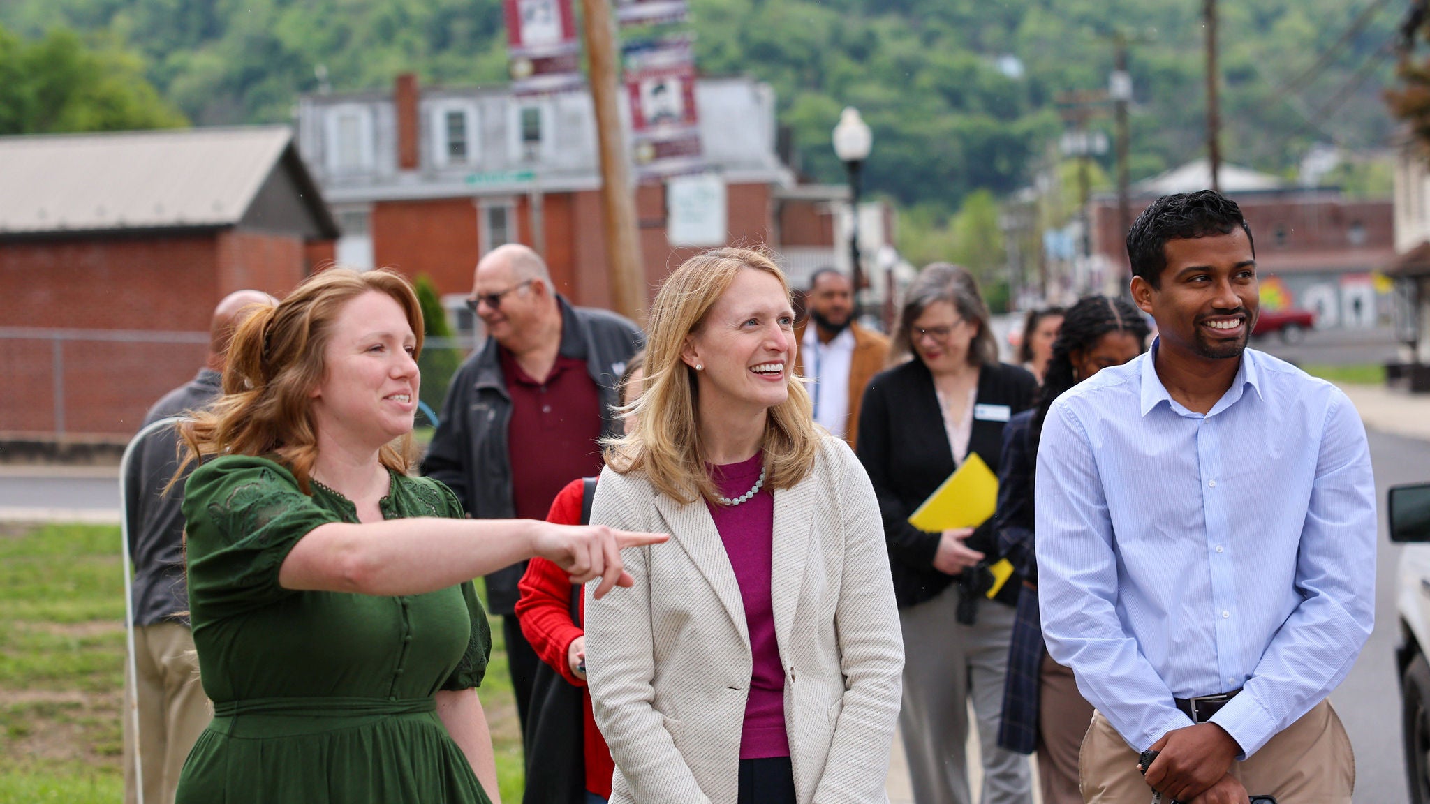 Comptroller Lierman visiting Westernport and Lonaconing on the one-year anniversary of the historic flooding in Western Maryland. She is walking with a group of people outside.