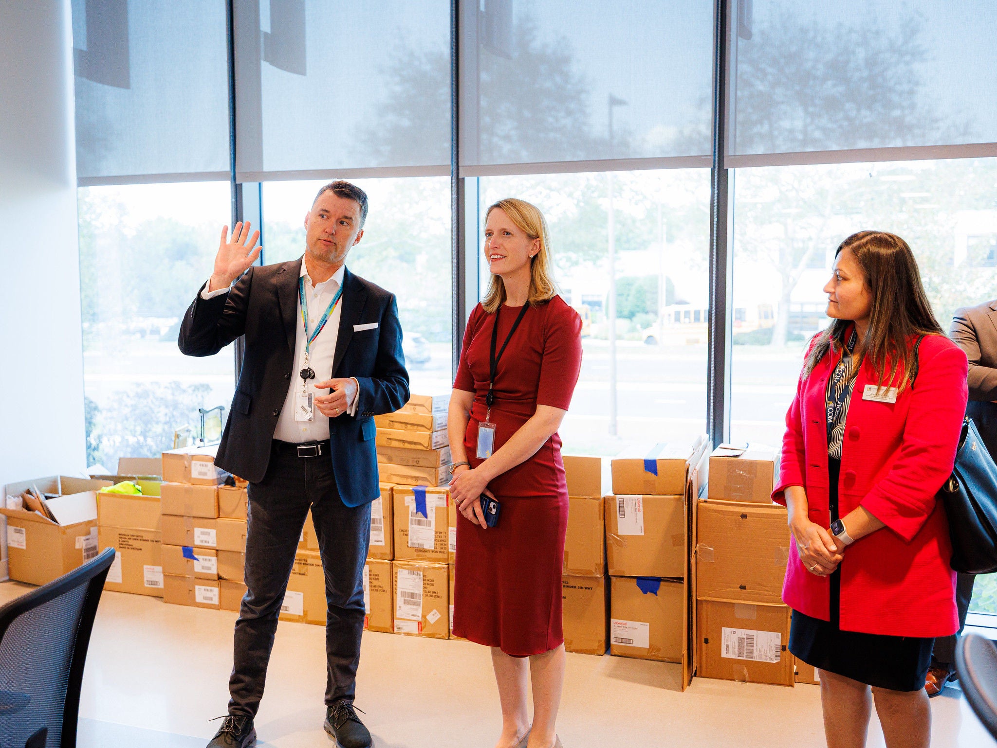 Comptroller Lierman looking on while a man is talking 