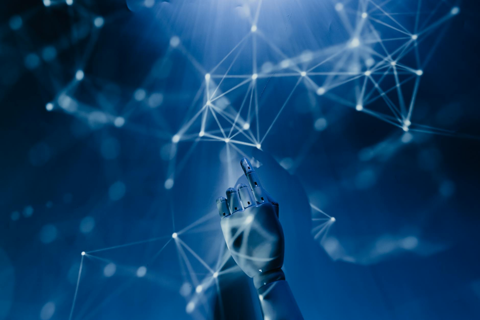 A robotic hand pointing up with a blue and white network web in the background