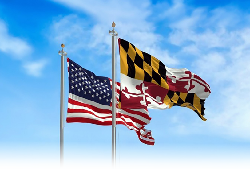 The Maryland and American flags side by side waving in the wind