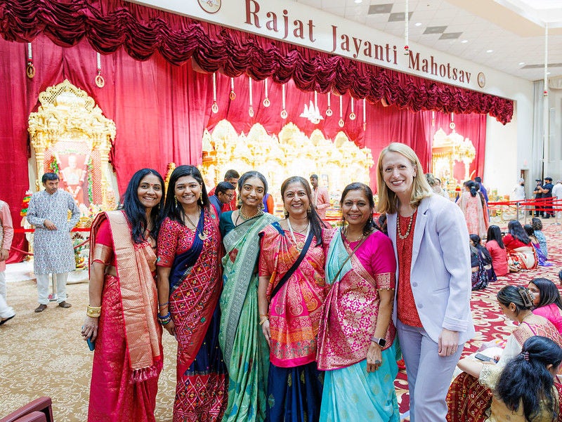 Comptroller Lierman standing with a group of Indian woman at a temple