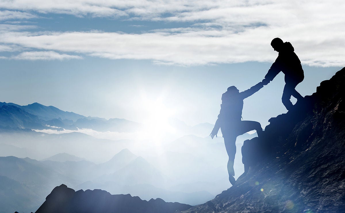 Mountaineers help each other to reach the summit