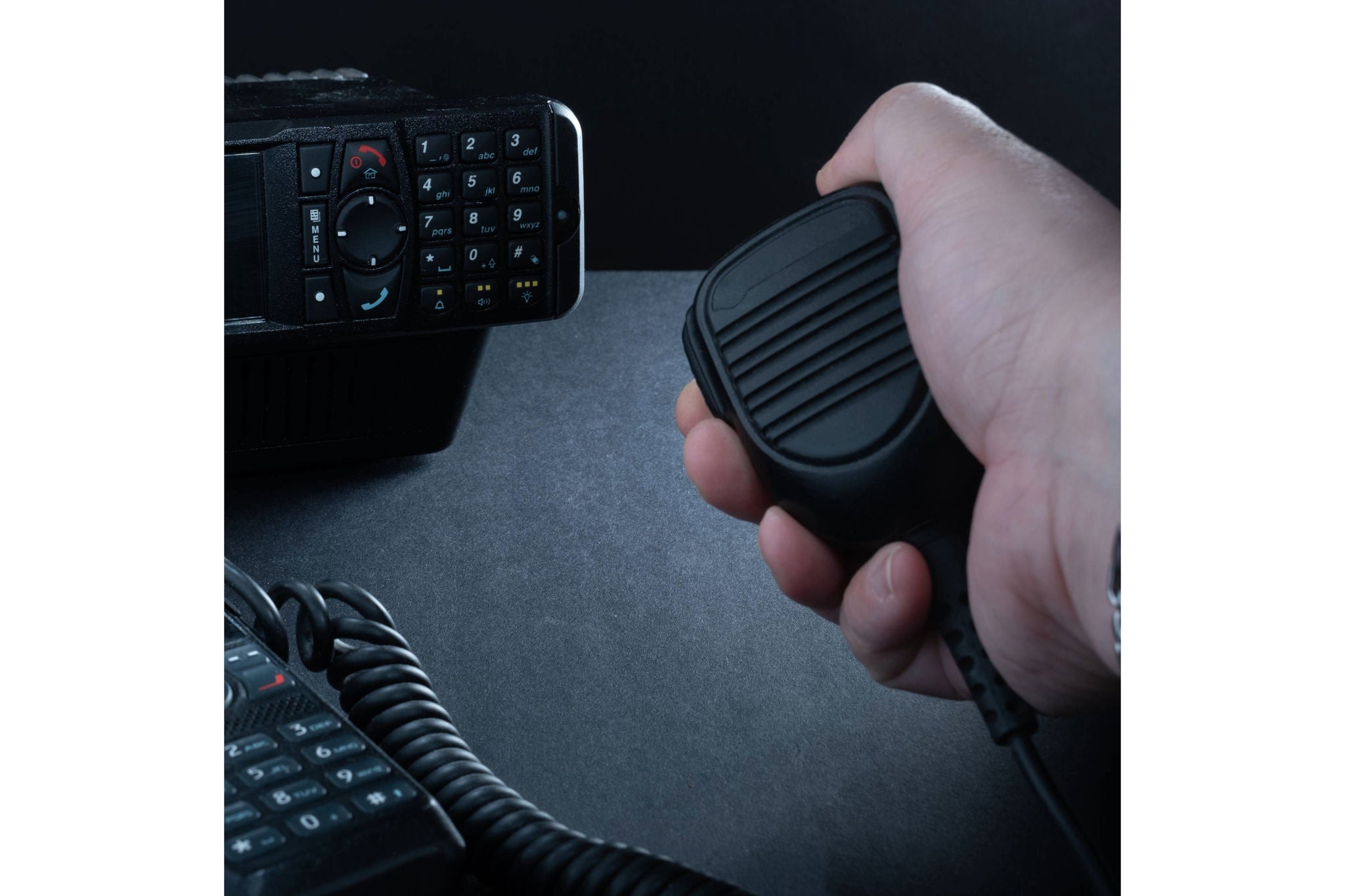 Helsinki / Finland - JANUARY 3, 2022: Closeup of pair of mobile two-way radios for Amateur radio operators against dark background.