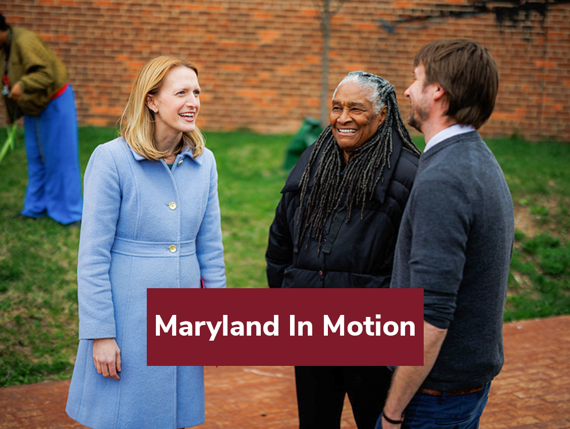 Brooke Lierman talking outside with a white male and a black woman.