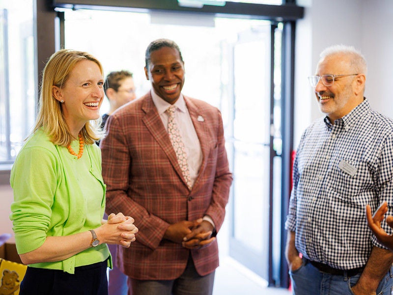 Comptroller Lierman standing with two people smilling