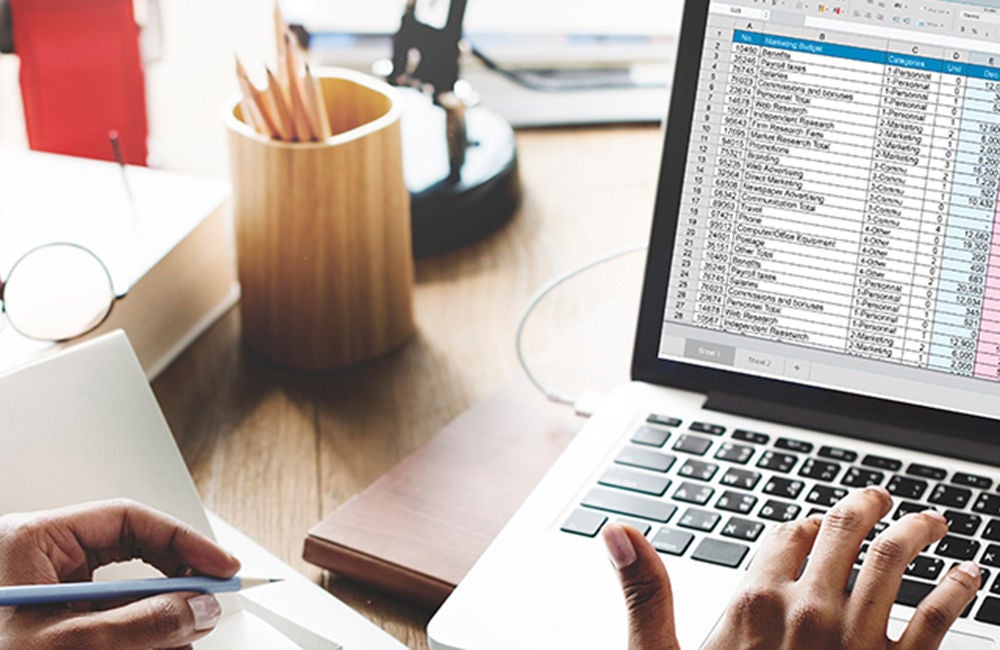 Person working on a spreadsheet on their laptop